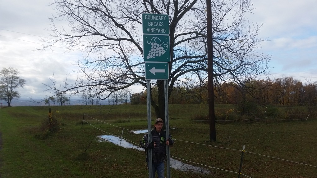 Vineyard Associate John Swick positions one of our signs near the edge of Al Mandigo's property.