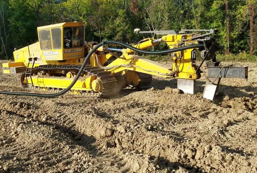 After ripping the soil to a depth of four feet, we installed plastic pipe, called "drainage tile", which removes all excess moisture from the soil beneath the vines. It forces the vines to grow deeper roots which makes them more cold-hardy and drought-tolerant.