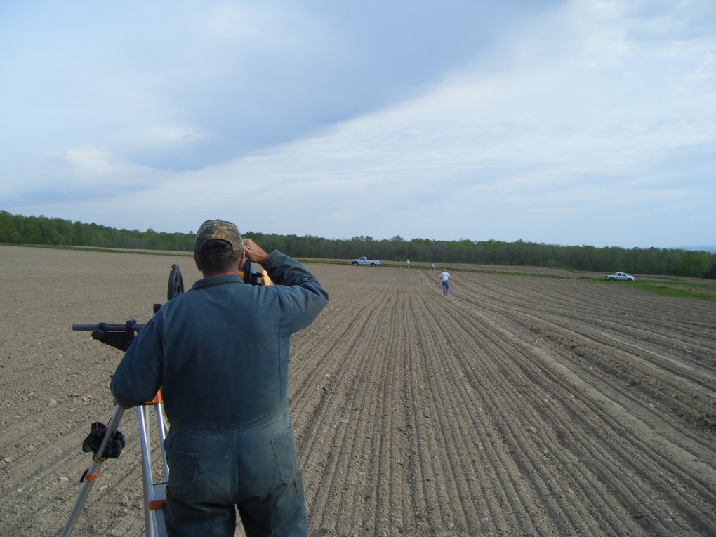 When you plant vines, it is helpful to plant them in extremely straight lines, using a laser, as is happening in this photo. The most efficient way to work in the vineyard is to mechanize as many of the viticultural steps as possible. Mechanized viticulture is much easier when the vines are planted in very straight line.