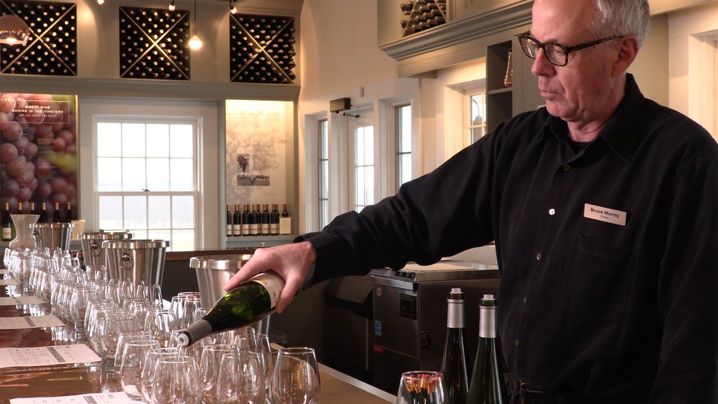 Boundary Breaks co-owner Bruce Murray behind the tasting bar preparing for a group tasting.